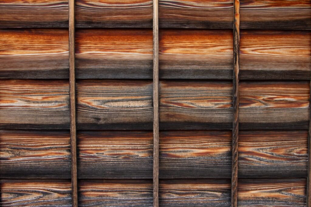 The wooden exterior walls of an old Japanese house. The wood grain and fittings are neatly arranged.