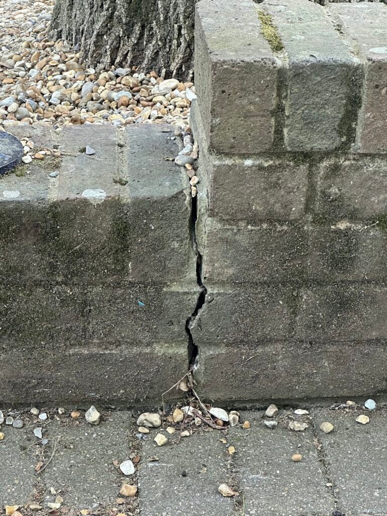 Vertical crack running through a concrete retaining wall