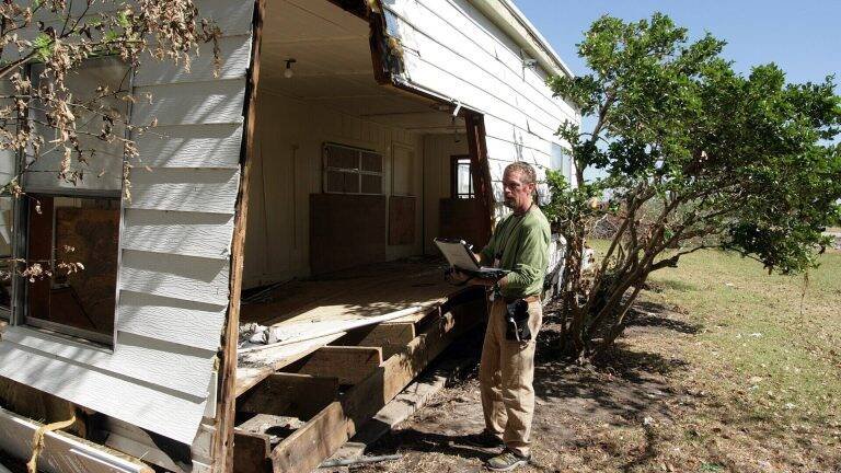 Inspector checking a house during a site visit